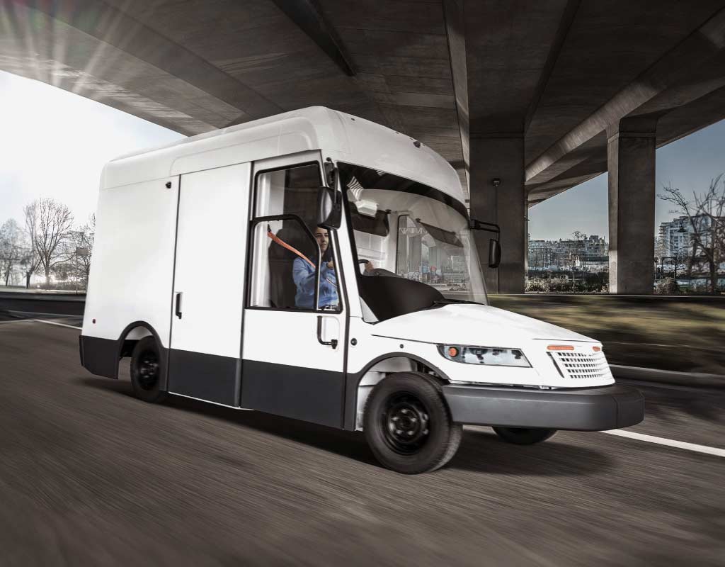 Oshkosh Next Generation Delivery Vehicle driving on a highway.